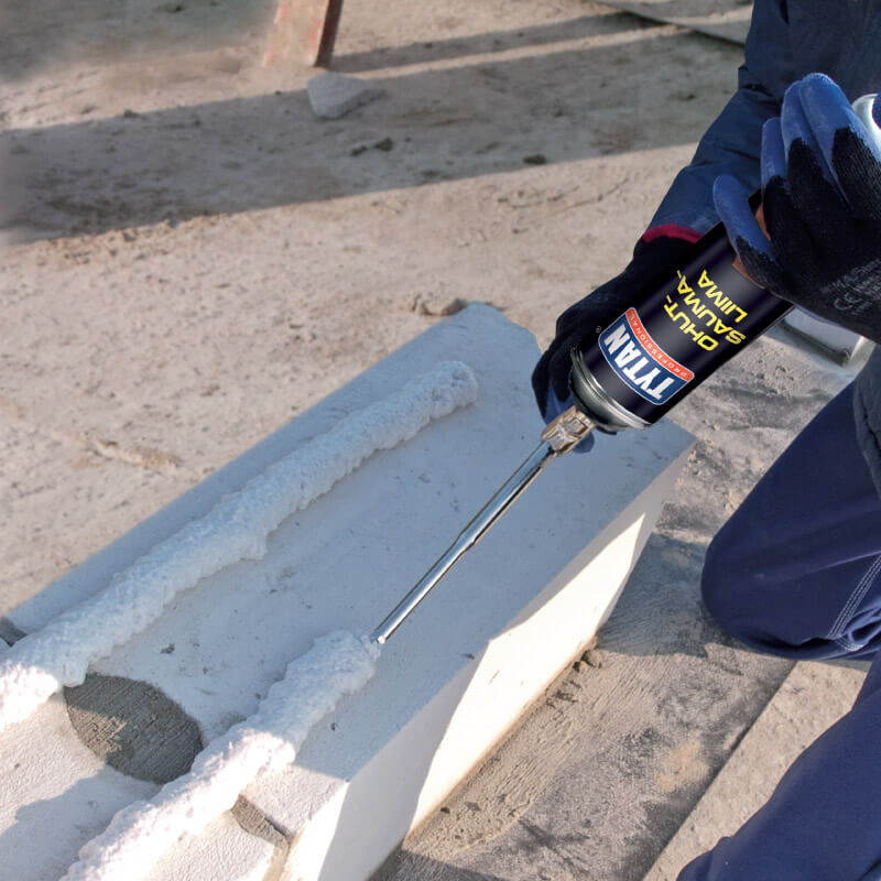 man installing concerete blocks with foam adhesive